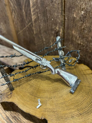Minature gun with barbed wire fence