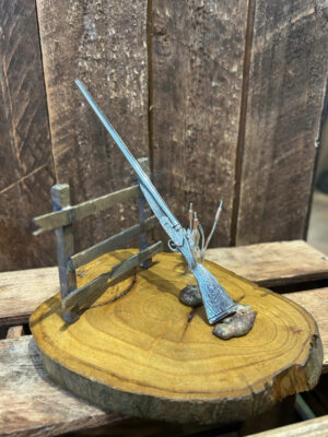 Minature gun with brass scene
